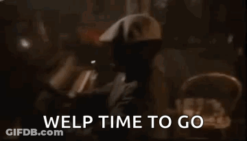 A Man In A Hat Is Standing In A Dark Room With The Words `` Welp Time To Go '' Written Above Him . GIF
