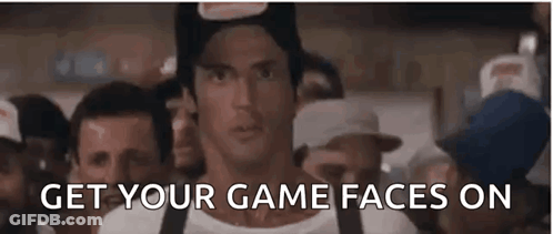 A Man In A Hat Is Standing In Front Of A Crowd Of People With The Words `` Get Your Game Faces On '' . GIF