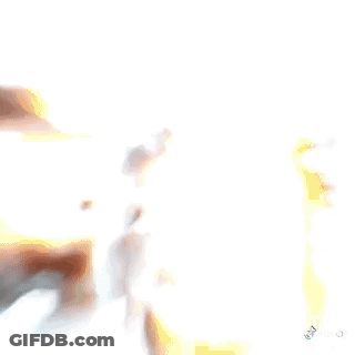 A Man In A Hat Is Standing In Front Of A White Van . GIF