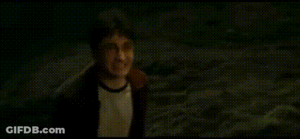 A Man In A Hat Is Standing In The Dark And Saying `` Coward '' . GIF