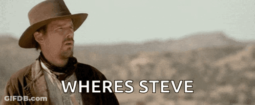 A Man In A Hat Is Standing In The Desert With The Words " Wheres Steve " Below Him GIF