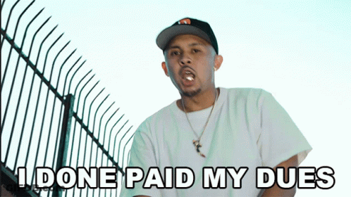 A Man In A Hat Says " I Done Paid My Dues " In Front Of A Fence GIF
