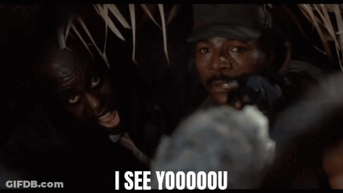 A Man In A Hat Says " I See Yoooou " In Front Of A Group Of People GIF