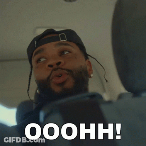 A Man In A Hat Says Ooohh In Front Of His Face GIF