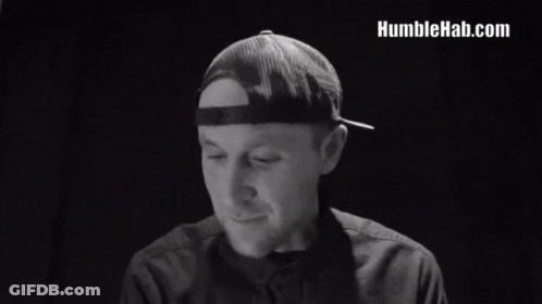 A Man In A Hat Says We Are Human After All In A Black And White Photo GIF