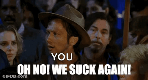 A Man In A Hat Says " You Oh No We Suck Again " In Front Of A Crowd GIF