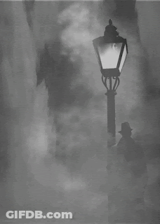 A Man In A Hat Stands In Front Of A Street Light GIF