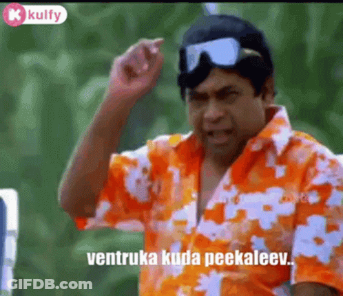 A Man In A Hawaiian Shirt And Goggles Is Making A Funny Face . GIF