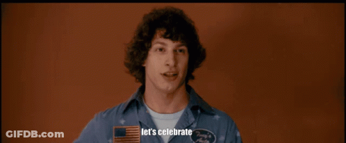 A Man In A Hawaiian Shirt Is Holding A Piece Of Bubble Wrap In A Room With Other Men GIF