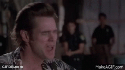 A Man In A Hawaiian Shirt Is Making A Funny Face In Front Of A Group Of Police Officers . GIF