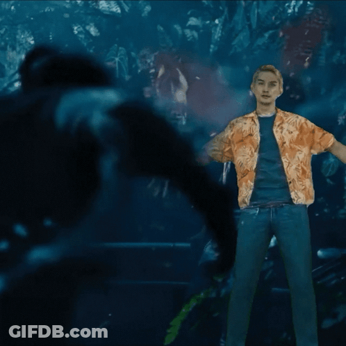 A Man In A Hawaiian Shirt Is Standing In The Dark GIF
