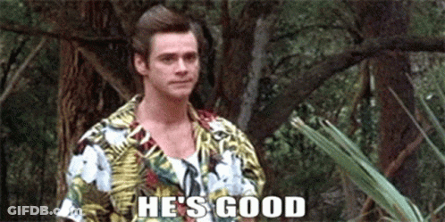 A Man In A Hawaiian Shirt Is Standing In The Woods And Saying He 'S Good . GIF