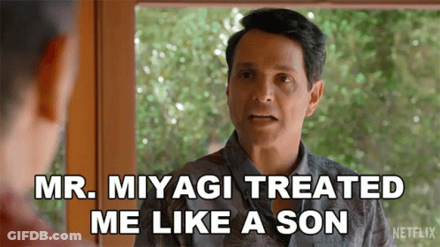 A Man In A Hawaiian Shirt Is Talking To Another Man And Saying Mr. Miyagi Treated Me Like A Son . GIF