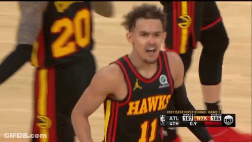 A Man In A Hawks Jersey Stands On A Basketball Court GIF