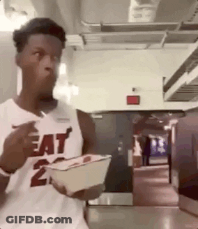 A Man In A Heat Jersey Is Eating A Meal From A Bowl . GIF