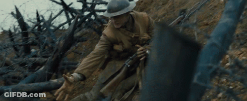 A Man In A Helmet Holds A Rifle In A Trench GIF
