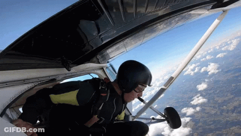 A Man In A Helmet Is Flying Through The Air GIF