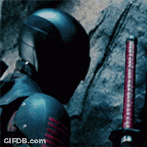A Man In A Helmet Is Holding A Red Sword GIF