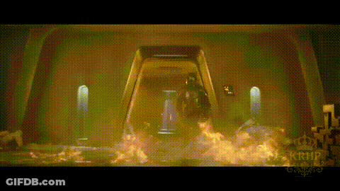 A Man In A Helmet Is Standing In Front Of A Door That Is On Fire . GIF