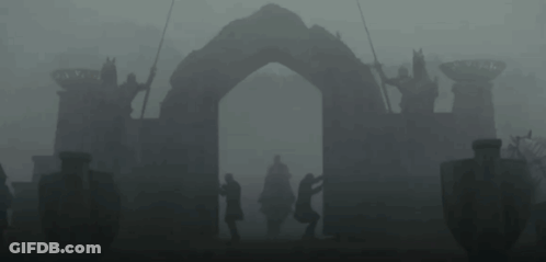 A Man In A Helmet Is Standing Next To Another Man In A Black Suit . GIF