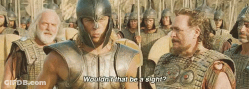 A Man In A Helmet Is Talking To Another Man In Armor In Front Of A Group Of Soldiers . GIF