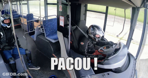 A Man In A Helmet Sits In The Driver 'S Seat Of A Bus With The Words Pacou Written On The Bottom GIF