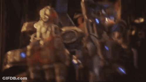 A Man In A Helmet With The Letter D On It Looks At Another Man GIF