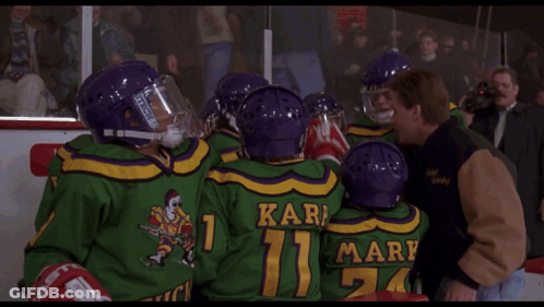 A Man In A Hockey Helmet Is Talking To Another Man And The Words Mac Mac Are Visible GIF