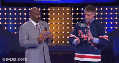 A Man In A Hockey Jersey Is Standing Next To A Man In A Suit And Tie On A Stage . GIF