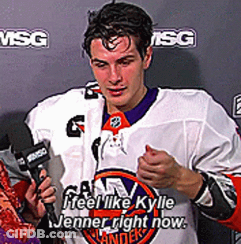 A Man In A Hockey Jersey Is Talking Into A Microphone And Says " Feel Like Kyle Jenner Right Now " GIF