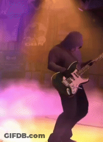 A Man In A Hood Is Playing An Electric Guitar GIF