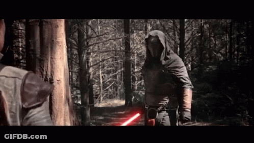 A Man In A Hooded Cape Is Holding A Red Lightsaber GIF