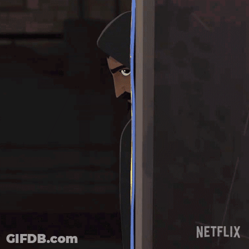A Man In A Hooded Cape Is Peeking Out From Behind A Wall With A Netflix Logo In The Corner GIF