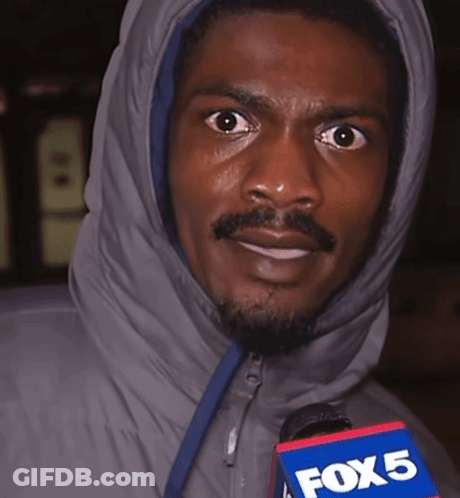 A Man In A Hooded Jacket Holds A Fox 5 Microphone In His Hand GIF