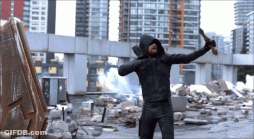 A Man In A Hooded Jacket Is Holding A Knife GIF
