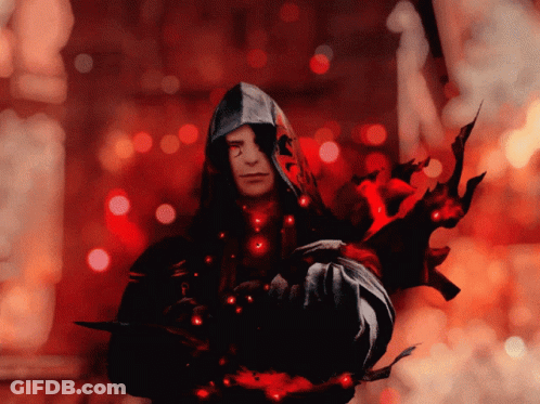 A Man In A Hooded Jacket Is Holding A Sword In His Hand GIF