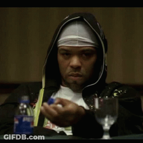A Man In A Hooded Jacket Is Sitting At A Table With A Pepsi Bottle GIF