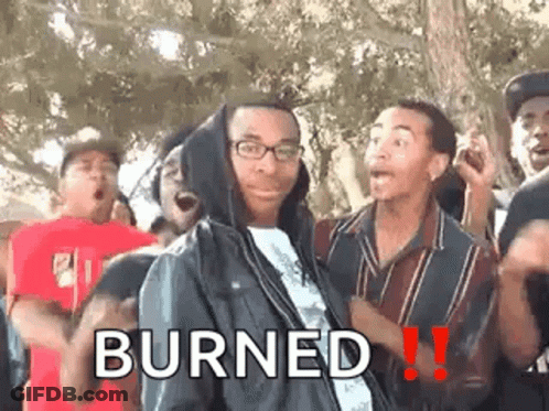 A Man In A Hooded Jacket Is Standing In Front Of A Group Of People And Says Burned . GIF
