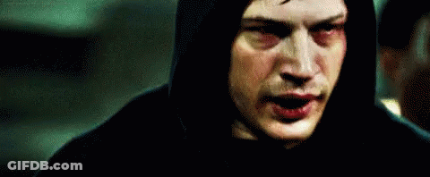 A Man In A Hooded Jacket Is Standing In Front Of A Mirror . GIF