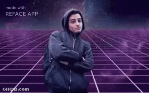 A Man In A Hooded Jacket Is Standing In Front Of A Purple Grid With The Words Hackerman Written On It GIF