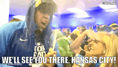 A Man In A Hooded Jacket Says We 'Ll See You There Kansas City In Front Of A Crowd Of People GIF
