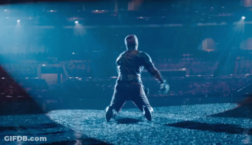 Man In Hooded Jacket Standing On Stage GIF