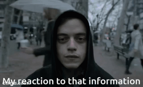 A Man In A Hooded Jacket With The Words My Reaction To That Information Below Him GIF