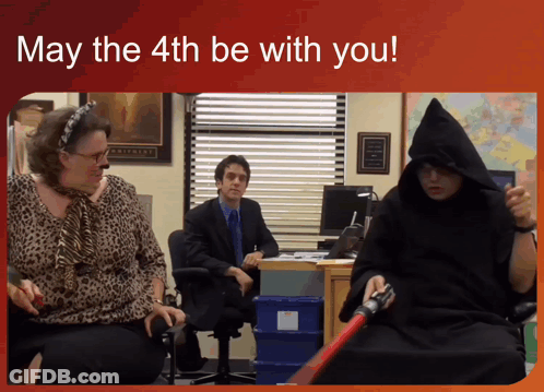 A Man In A Hooded Robe Is Holding A Darth Vader Lightsaber GIF
