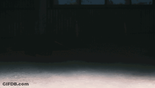 A Man In A Hooded Sweatshirt Is Running In The Dark GIF