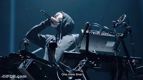 A Man In A Hooded Sweatshirt Playing A Keyboard That Says Advanc GIF