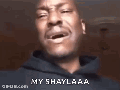 A Man In A Hoodie Is Crying With His Mouth Open And The Words `` My Shaylaa '' Written On His Face . GIF