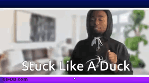 A Man In A Hoodie Is Dancing In A Living Room With The Words `` Stuck Like A Duck '' . GIF