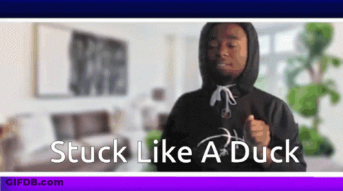 A Man In A Hoodie Is Dancing In A Living Room With The Words Stuck Like A Duck Below Him . GIF