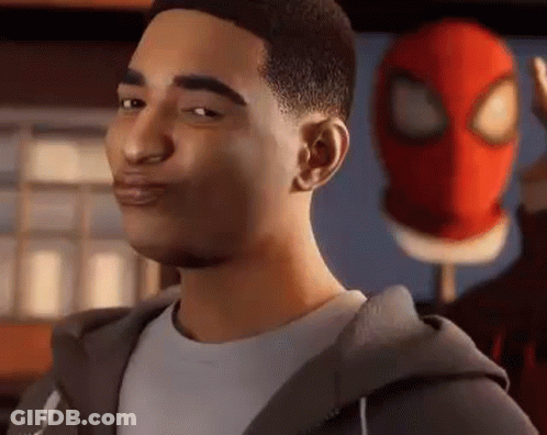 A Man In A Hoodie Is Standing In Front Of A Spiderman Mask . GIF